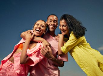 Two single women and a single man enjoying a Match dating event.